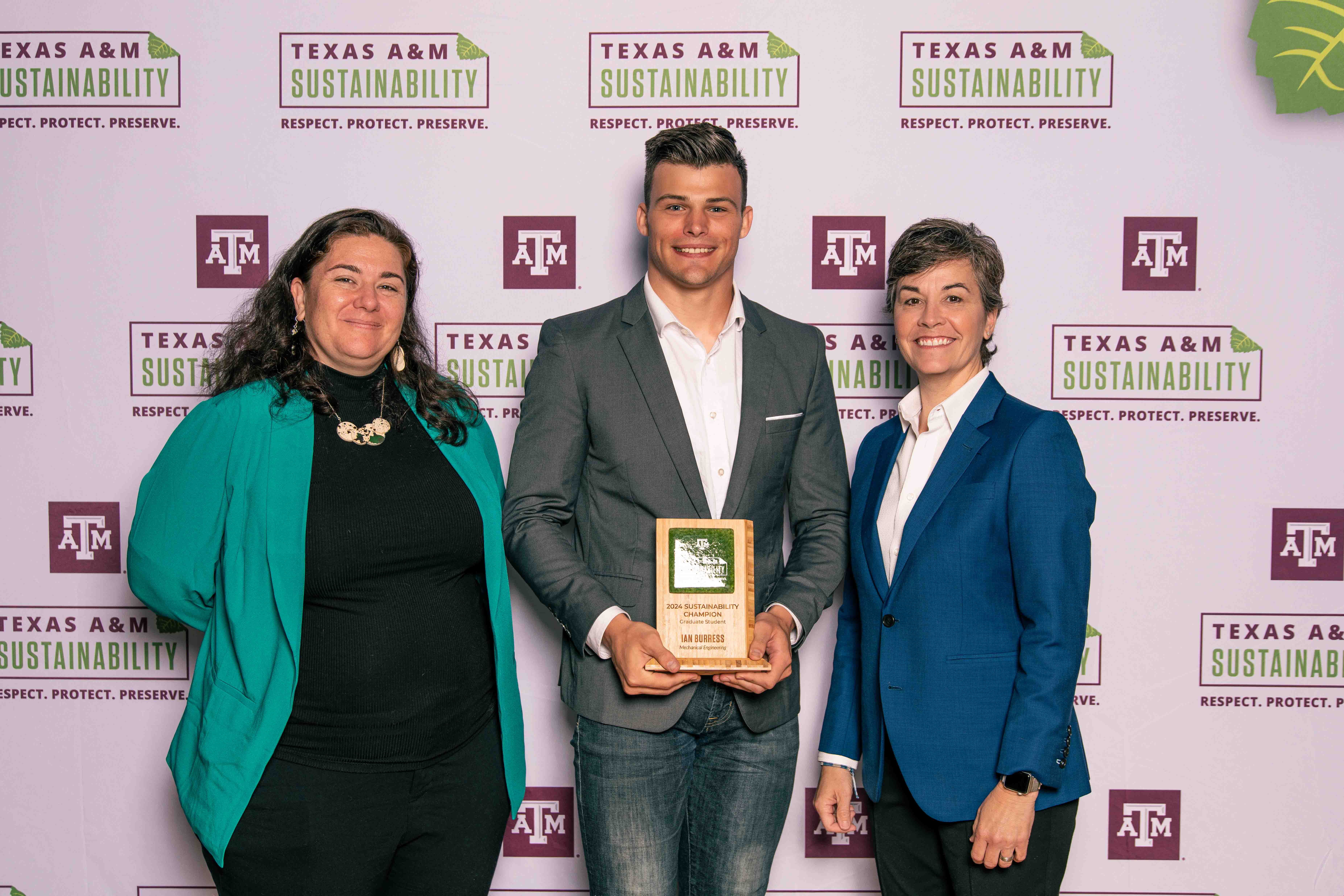 Ian Burress accepting the Sustainability Champion Graduate Award with Kelly Wellman and Ben Kalscheur